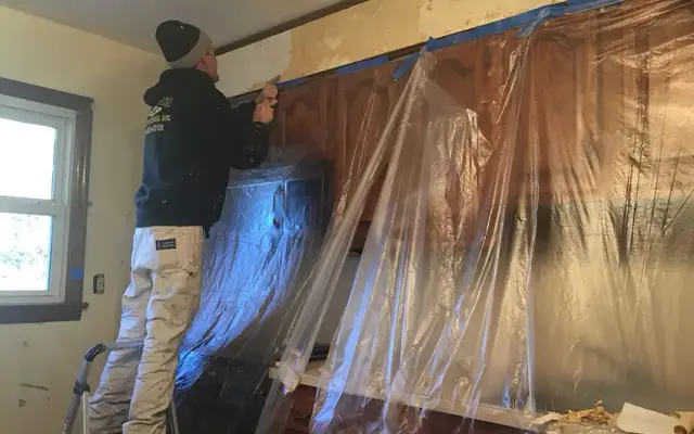 Room masked and sheeted before painting